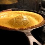 Dutch baby pancake cooking in the oven